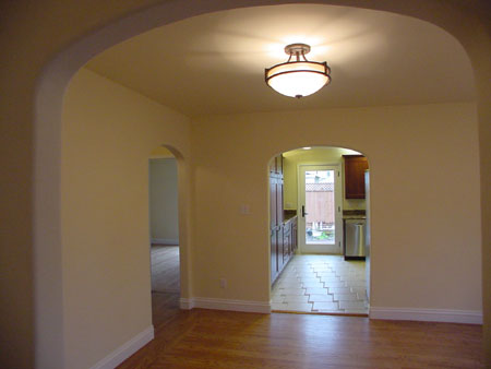 Dining Room - View from entry. Kitchen, bedroom, stairwell entry beyond.